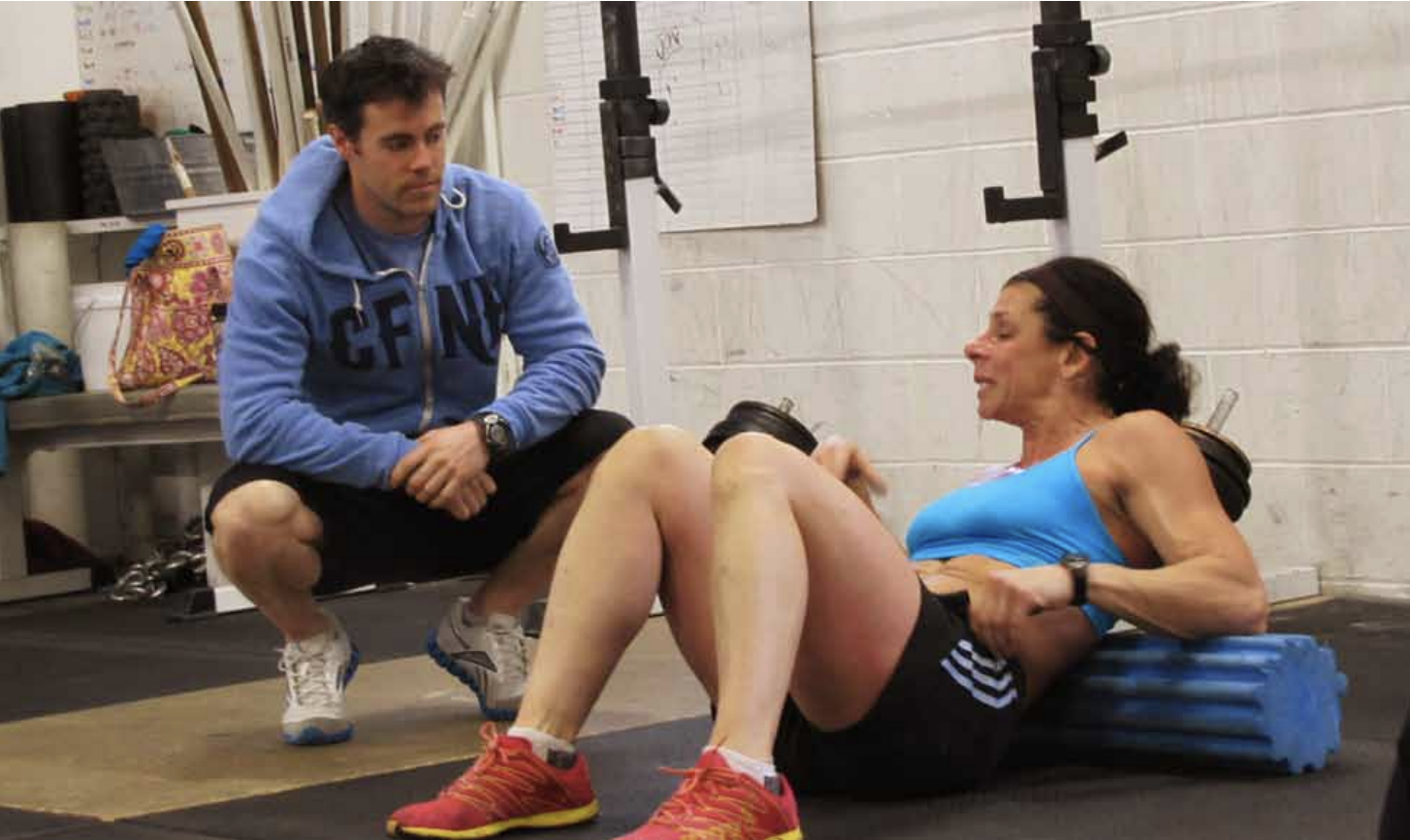 Ben Bergeron works with an athlete at CrossFit New England.