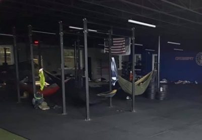 Lineworkers sleep in hammocks suspended from a pull-up rig.