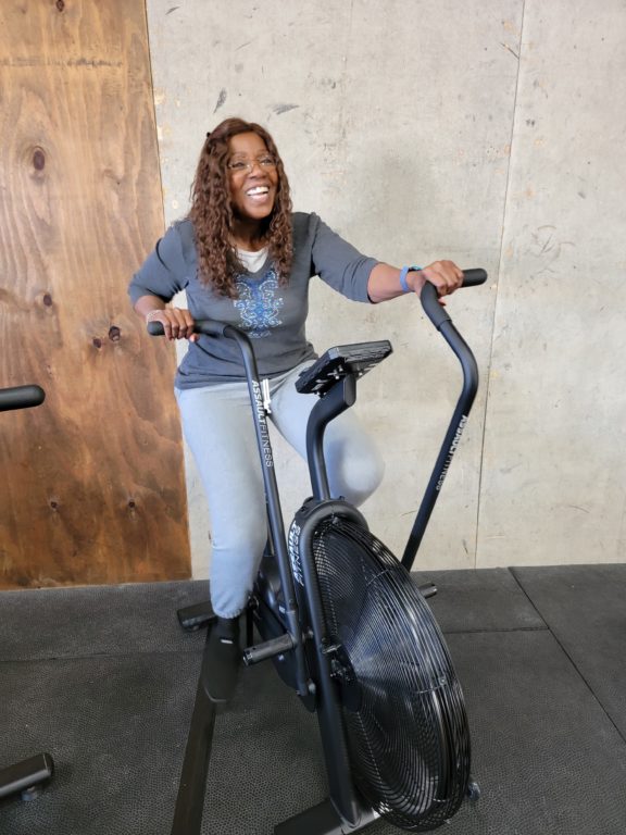 Gloria Gaynor on an Assault bike at Vivamus CrossFit