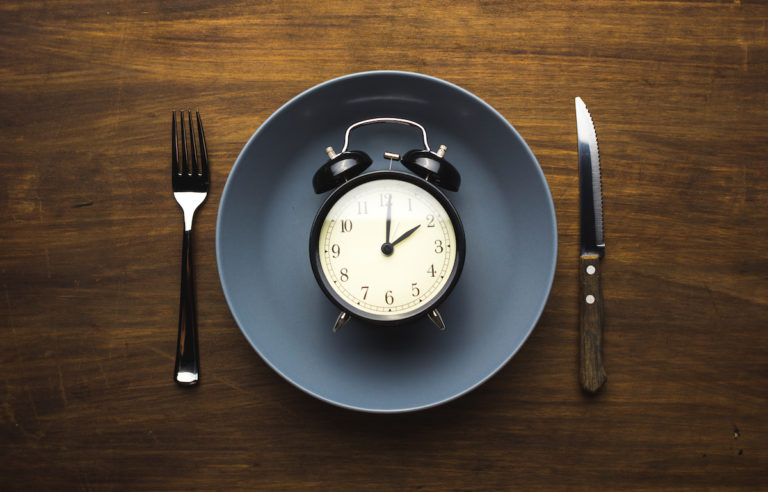 A dinner plate with a clock on it.