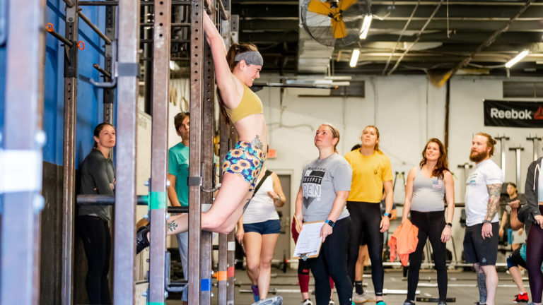 Woman doing a kipping pull-up