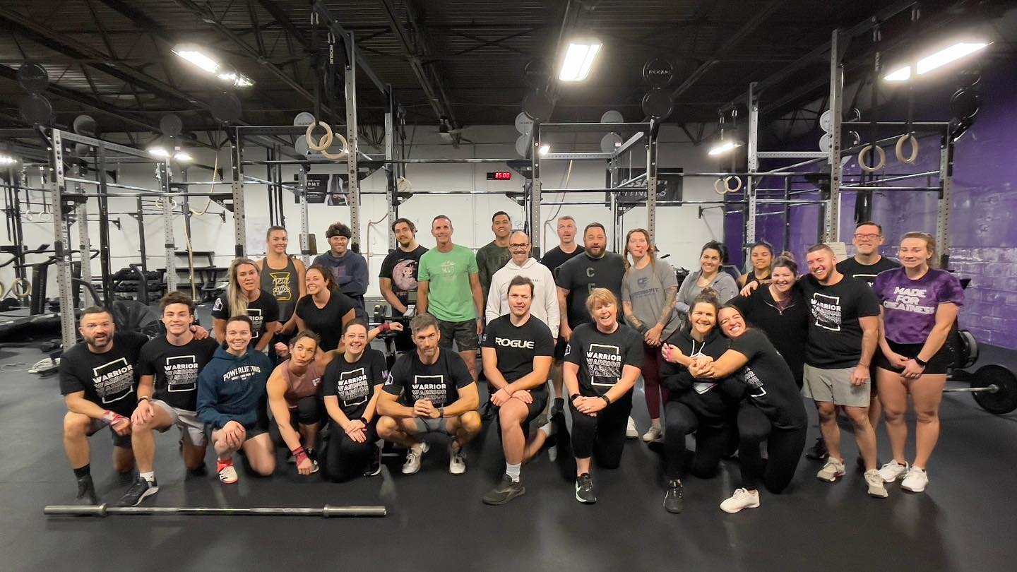 Smiling members of M4G CrossFit pose for a group photo