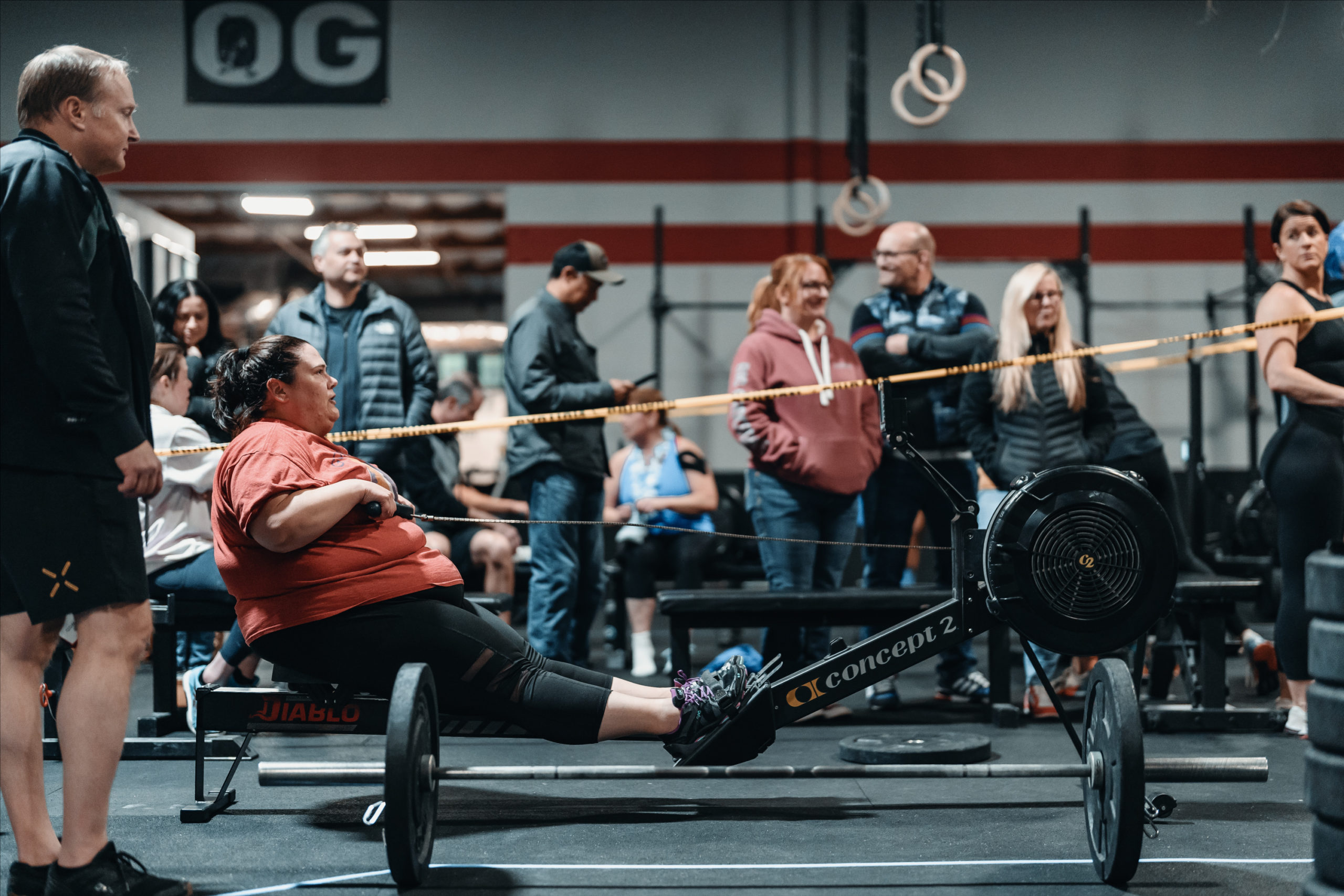 A woman in a red shirt on a rower during Open Test 23.1