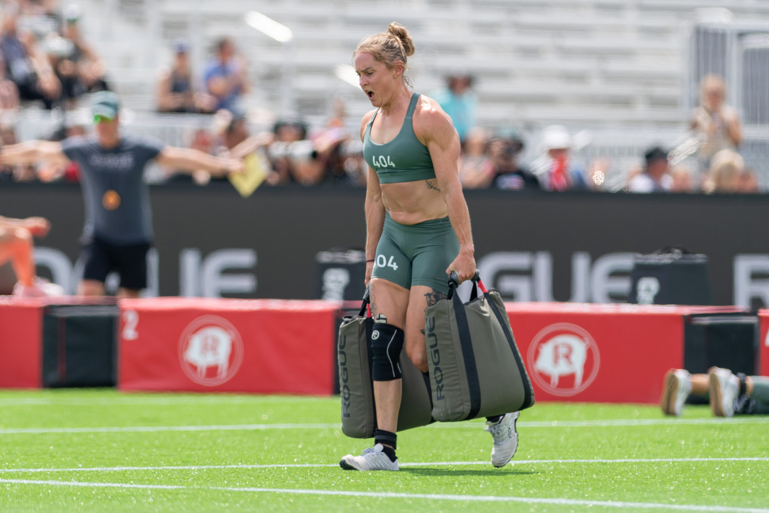 Sam Briggs carries sandbags at the 2023 NOBULL CrossFit Games