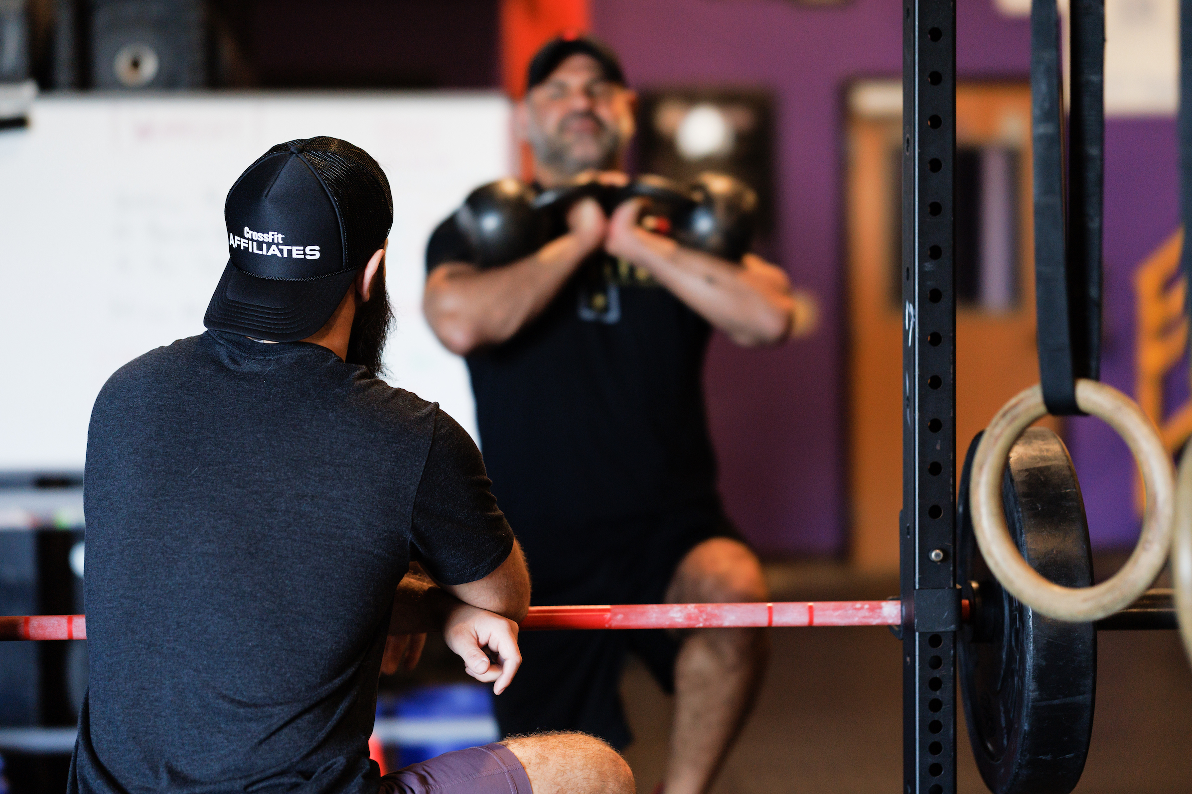 A coach observes an athlete.