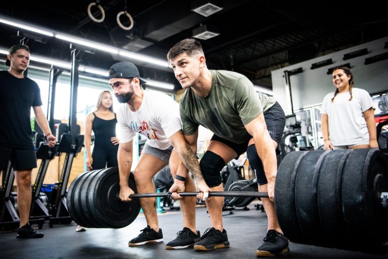 Two men deadlifting the same bar