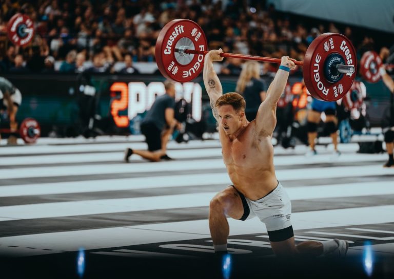 Noah Ohlsen lunging a barbell overhead at the 2023 CrossFit Games