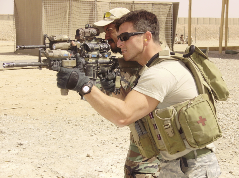 Rich Cliff aiming a firearm in uniform while deployed