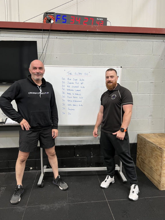 Scott Hanley standing next to a whiteboard at CrossFit Belfast