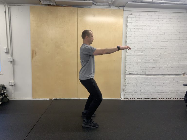 CrossFit athlete showing improper squat initiation
