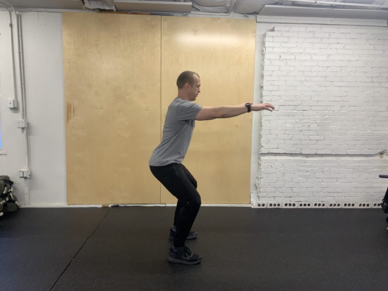 CrossFit athlete showing proper squat initiation