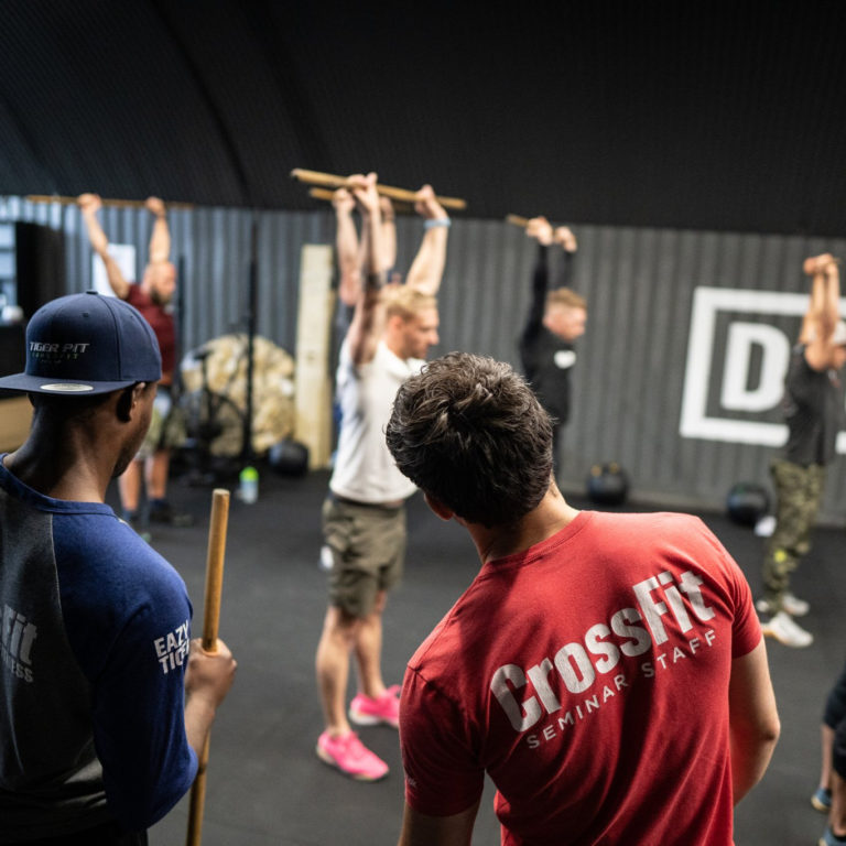 Image of a CrossFit Coach seeing and correcting