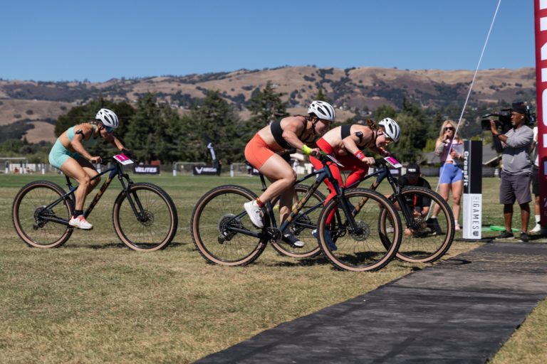Athletes crossing the finish line on bikes