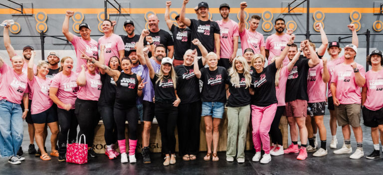 A large group of women and men wearing pink to support Breast Cancer.